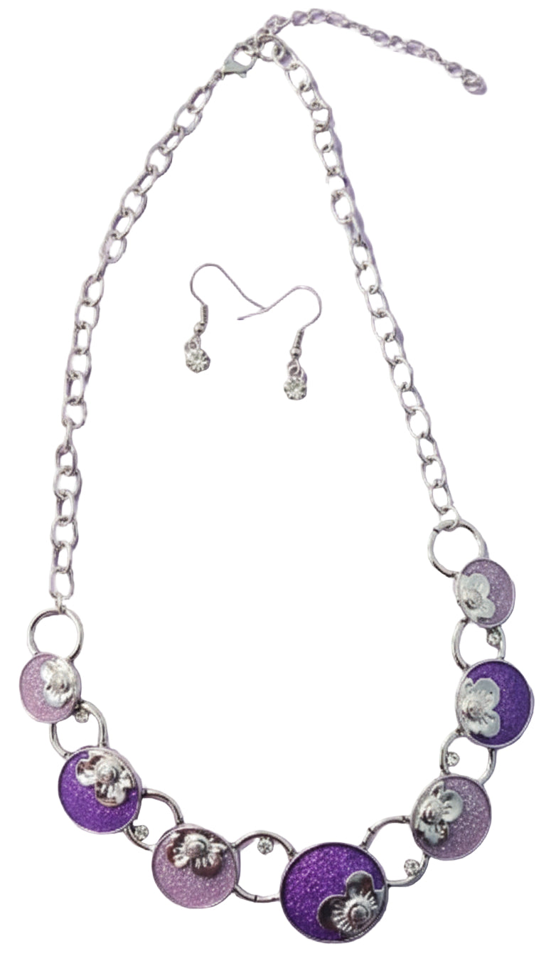 Necklace and earrings set with purple and silver circular pendants on a dark background