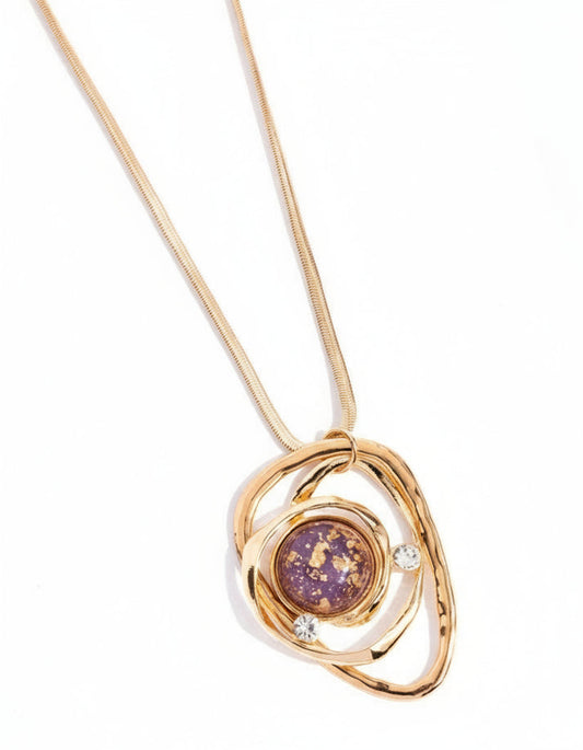 Gold necklace with a purple pendant on a white background