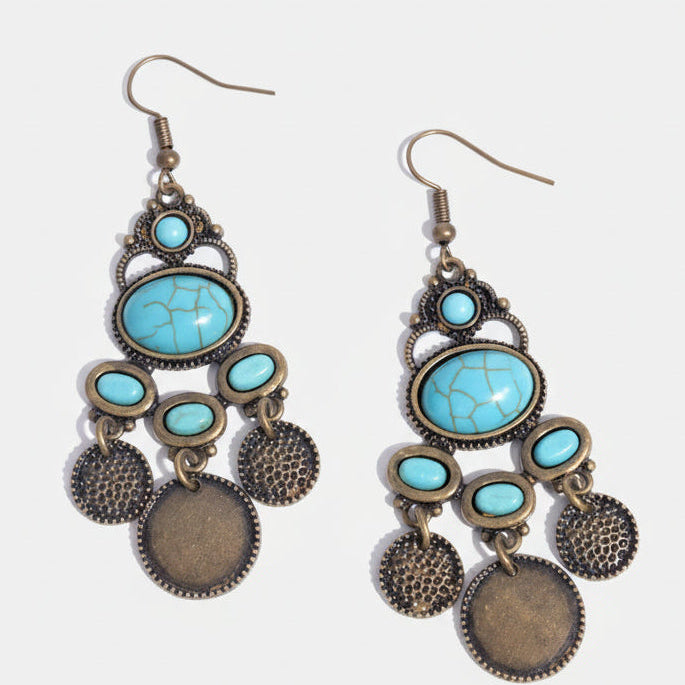 Pair of turquoise and bronze earrings on a white background