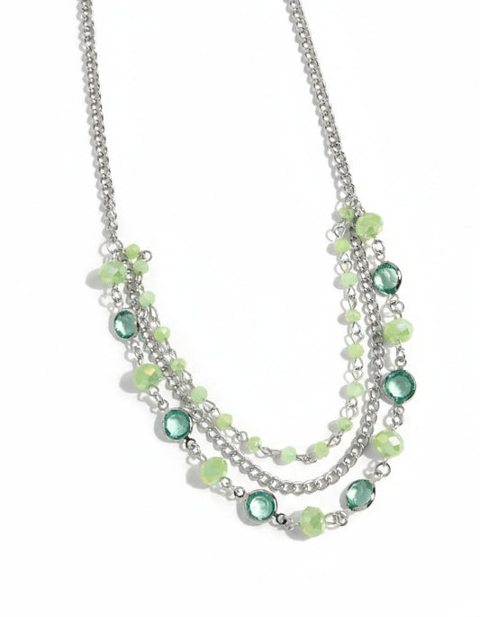 Necklace with green and silver beads on a white background