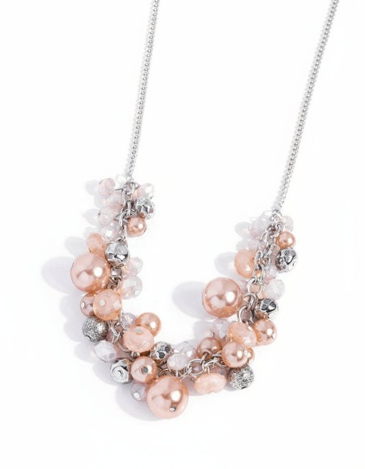 Necklace with pink and silver beads on a white background