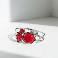 Silver bracelet with red hexagonal stones on a white background